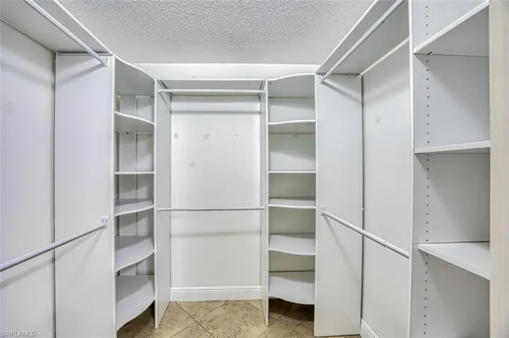 Walk in closet with built in cabinets
