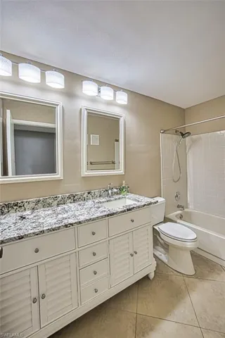 Guest bath with shower/tub combo. Tile floors