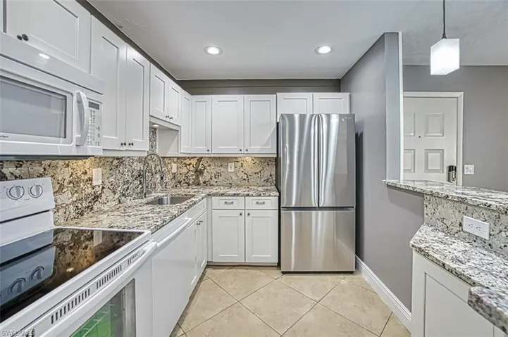 White cabinets, granite counter tops, french door refrigerator