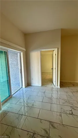 Empty room with baseboards and light marble finish floors