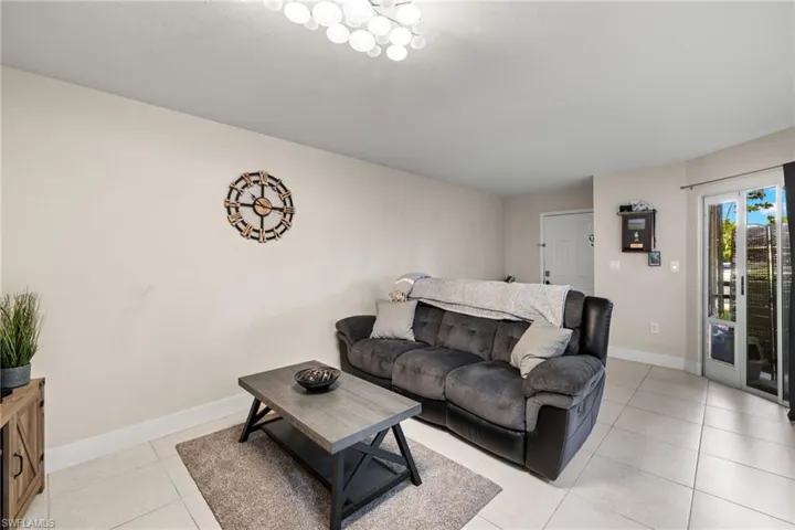 Living room with light tile patterned flooring