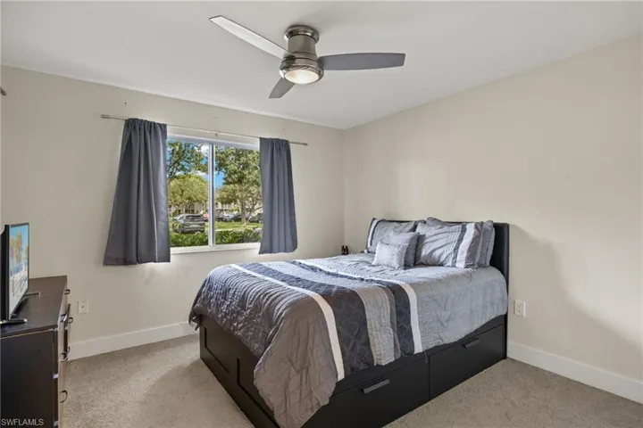 Bedroom featuring light colored carpet and ceiling fan