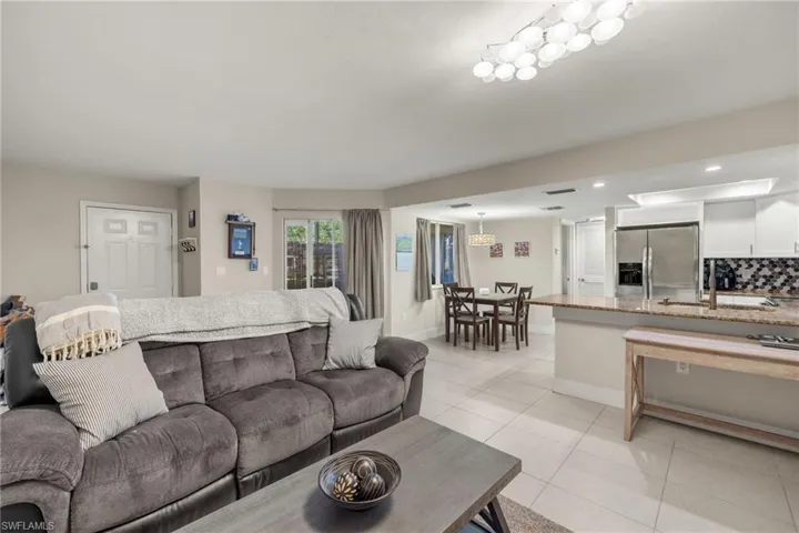 Tiled living room featuring sink