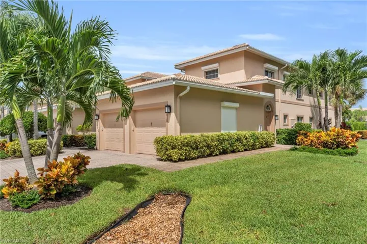 Mediterranean / spanish home with a garage, a wall mounted AC, and a front yard