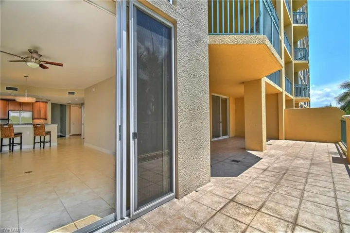 View of patio / terrace with a balcony and GREAT VIEW of the beautifully landscaped grounds.