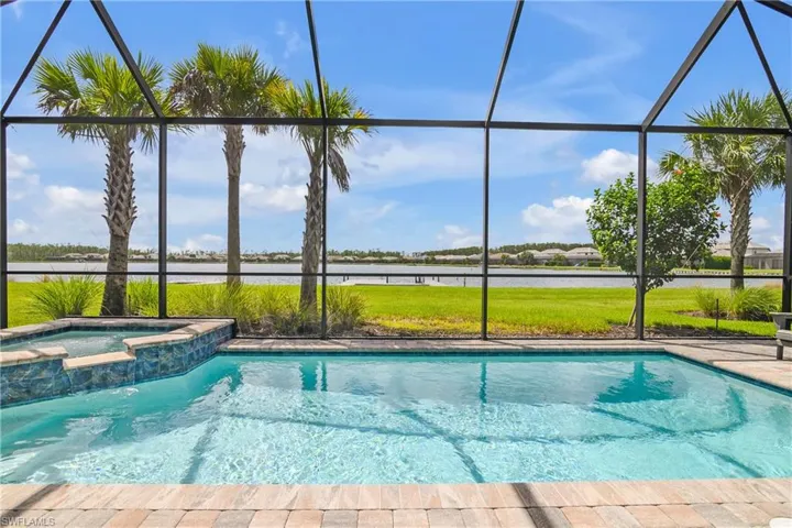 View of pool featuring a hot tub and a beautiful water view of Indigo boating lake.