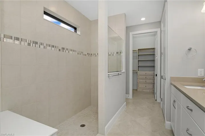 Spacious owner's bathroom shower and walk-in closet.
