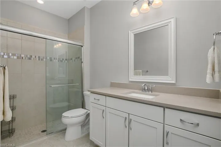 Guest bathroom featuring walk in shower.