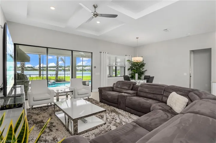 Living room with plenty of room for entertaining guests and great natural light, with a gorgeous lake view.