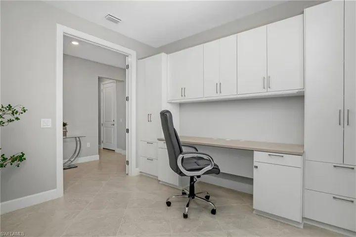 Private office space featuring custom built in cabinetry and desk.