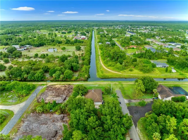 Aerial overview of property's location featuring property boundaries highlighted and nearby suburban area