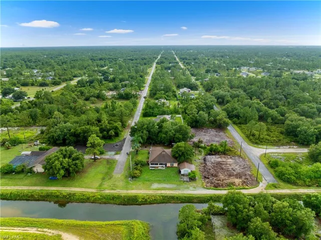 Aerial view of a nearby body of water and a heavily wooded area