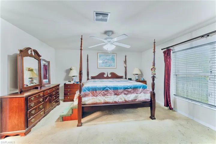 Bedroom featuring ceiling fan and light colored carpet