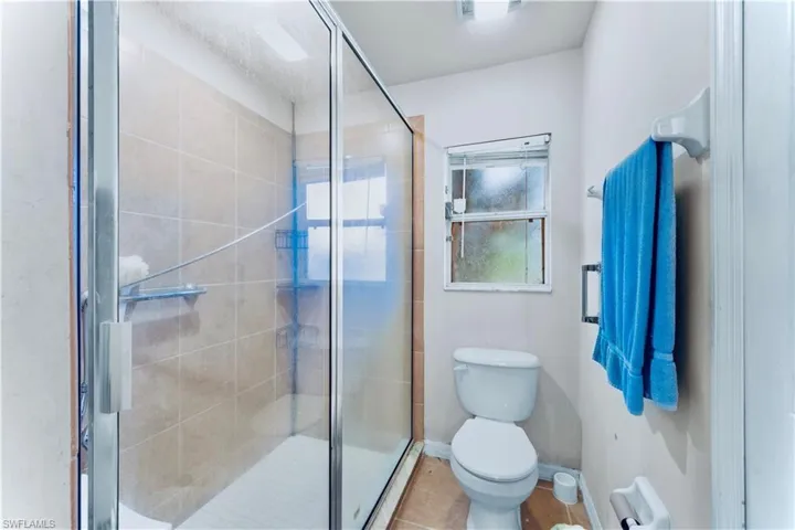 Full bathroom with a stall shower and tile patterned floors