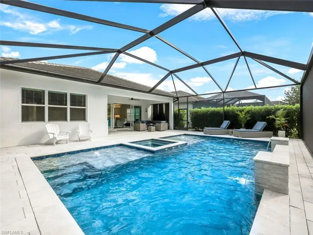 View of swimming pool with an outdoor living space, pool water feature, ceiling fan, a lanai, and an in ground hot tub