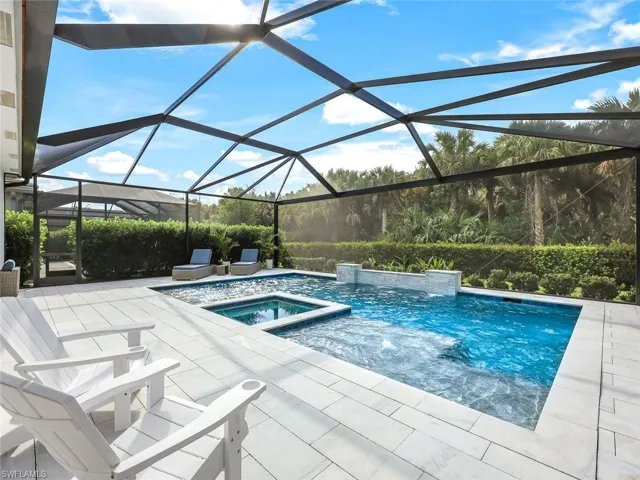View of pool with a patio area, a lanai, and an in ground hot tub