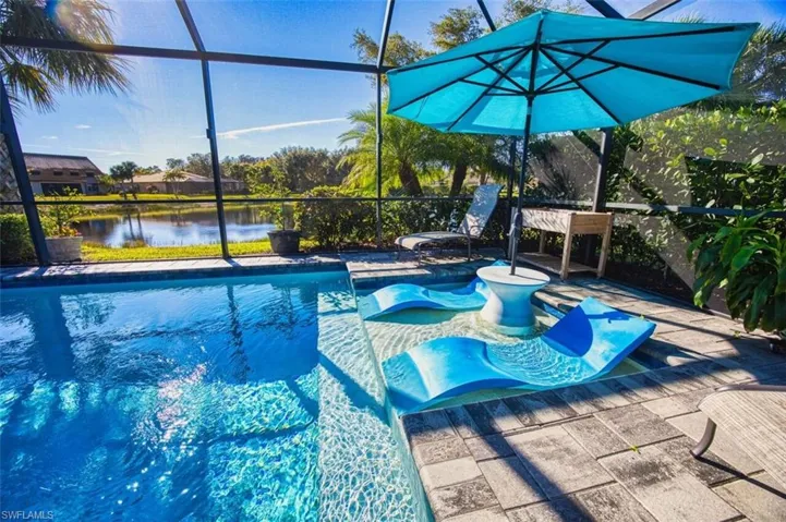 Outdoor pool featuring a lanai, a sunroom, and a water view
