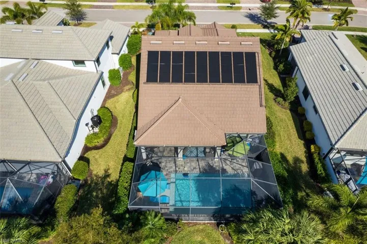 Aerial view of property and surrounding area featuring a pool area