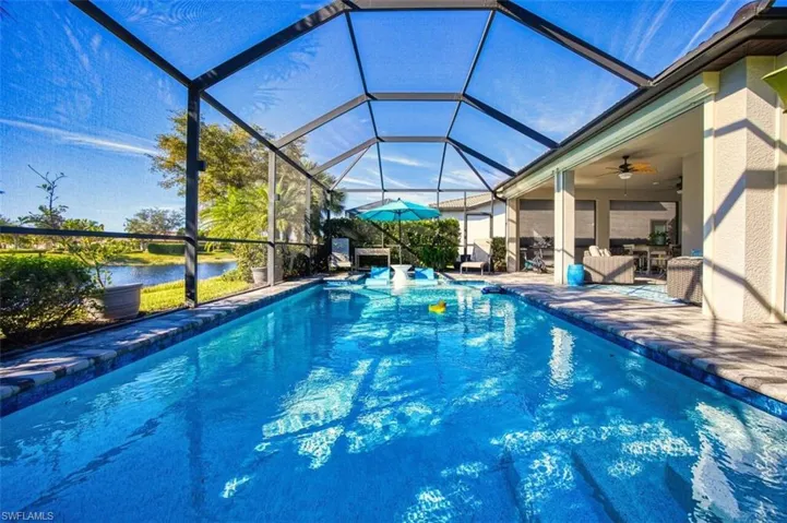 Outdoor pool featuring a lanai and water view