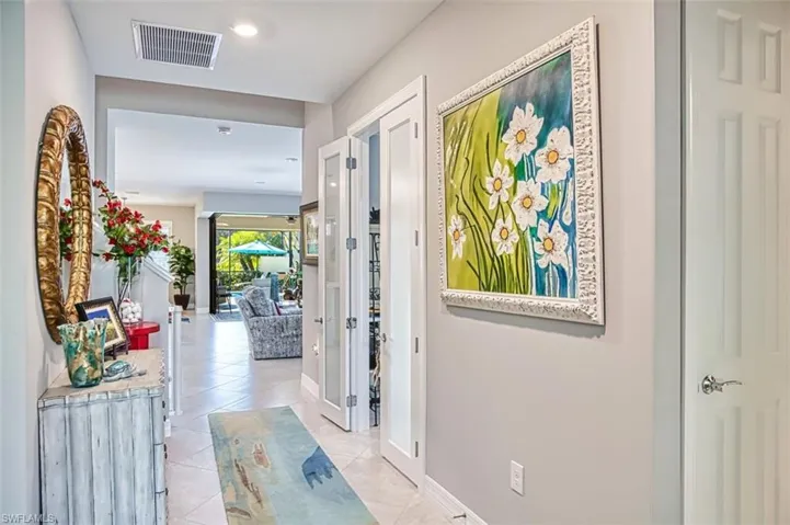 Hall featuring light tile patterned floors and recessed lighting