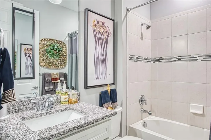 Bathroom featuring shower / bath combination and vanity