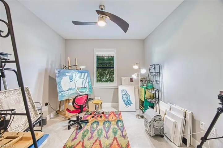 Recreation room featuring baseboards and a ceiling fan