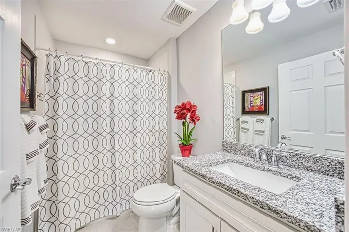 Full bathroom with vanity and a shower with shower curtain