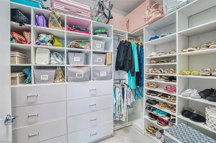 Spacious closet with light tile patterned floors