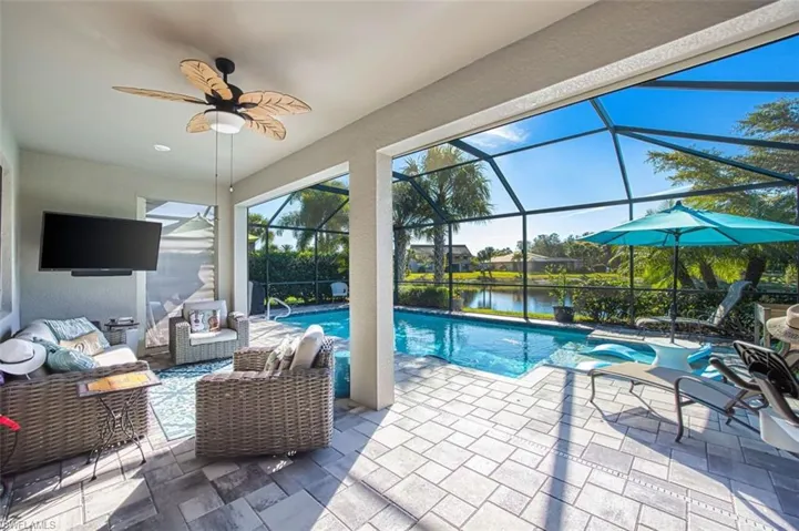 View of patio / terrace featuring outdoor lounge area, a lanai, a sunroom, a water view, and ceiling fan