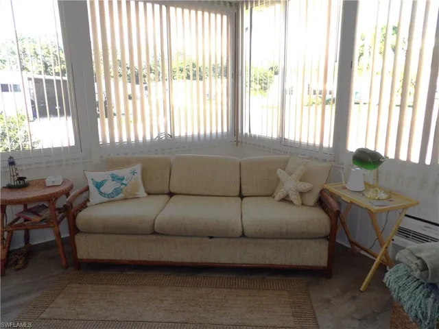 Sunroom featuring healthy amount of natural light and a water view
