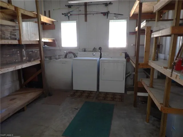 Below grade area featuring washing machine and clothes dryer