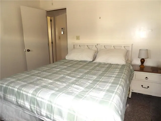 Bedroom featuring dark colored carpet