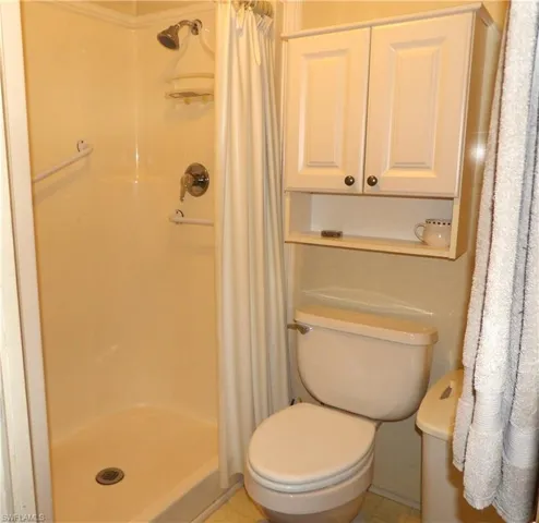 Bathroom with a stall shower and tile patterned flooring