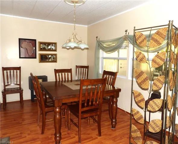 Dining room featuring wood finished floors and ornamental molding