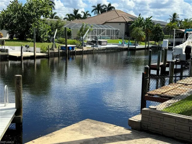 View of dock featuring a water view and a lanai