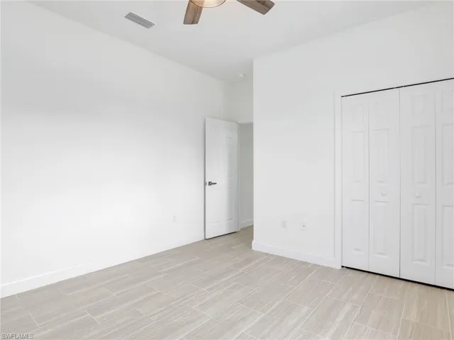 Unfurnished bedroom with a closet and ceiling fan