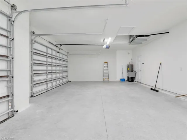Garage with a garage door opener and electric water heater