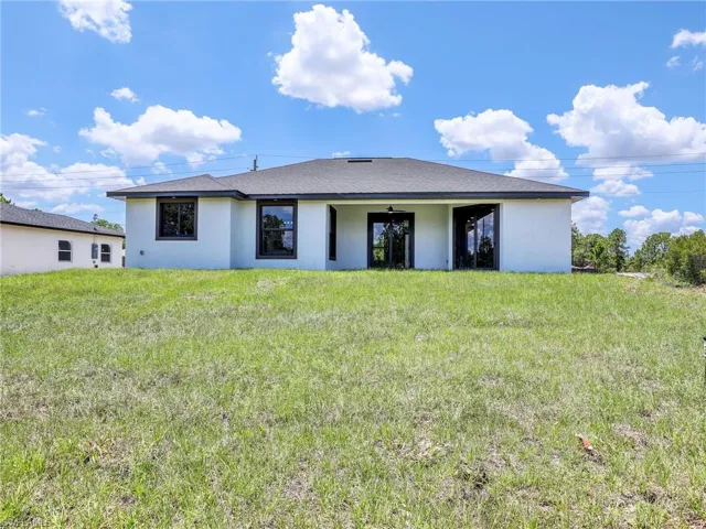 Back of house featuring a yard