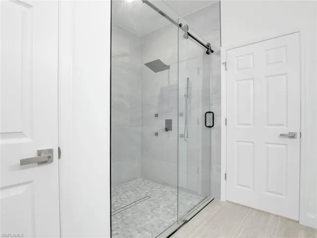 Bathroom with tile floors and an enclosed shower
