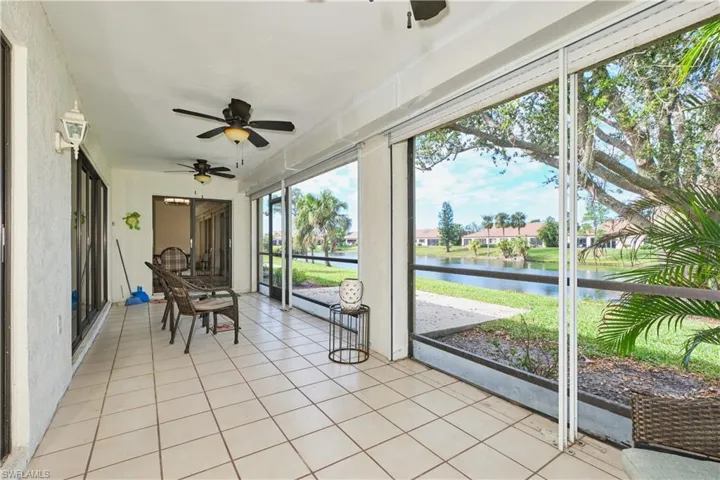 Sunroom / solarium featuring a water view and ceiling fan