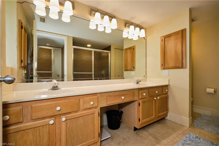 Full bath featuring a shower stall, visible vents, a sink, and tile patterned floors
