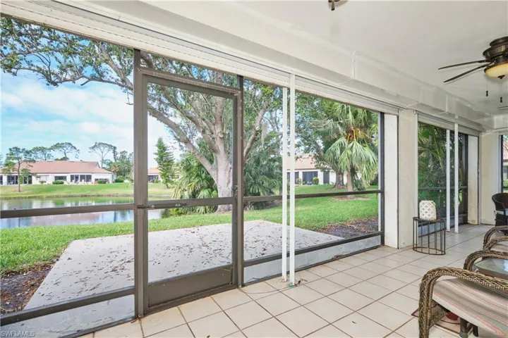 Sunroom featuring a ceiling fan, a wealth of natural light, and a water view