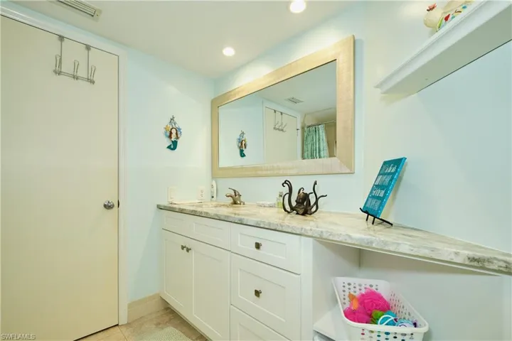 Bathroom with recessed lighting, visible vents, tile patterned flooring, and vanity