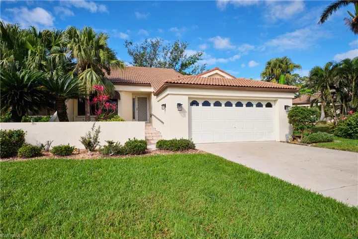 Mediterranean / spanish-style house featuring a tile roof, stucco siding, an attached garage, a front yard, and driveway