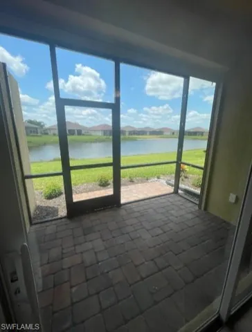 Unfurnished sunroom featuring a water view