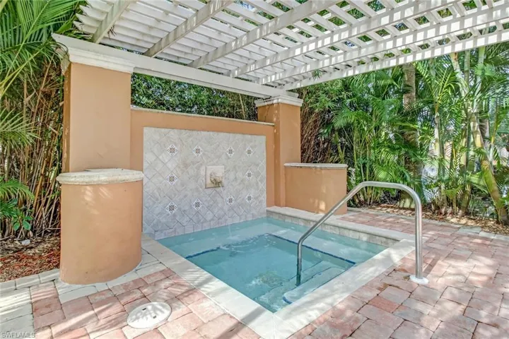 View of pool with patio surround, a pergola, and a community hot tub
