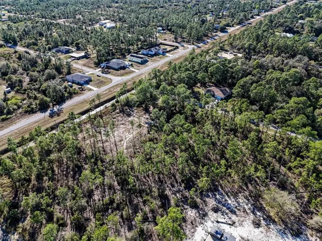 Aerial overview of property's location featuring a forest