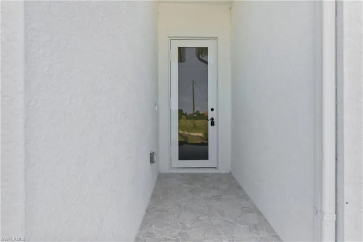 Property entrance with stucco siding