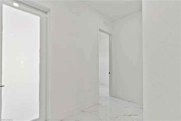 Bathroom featuring marble finish flooring and baseboards