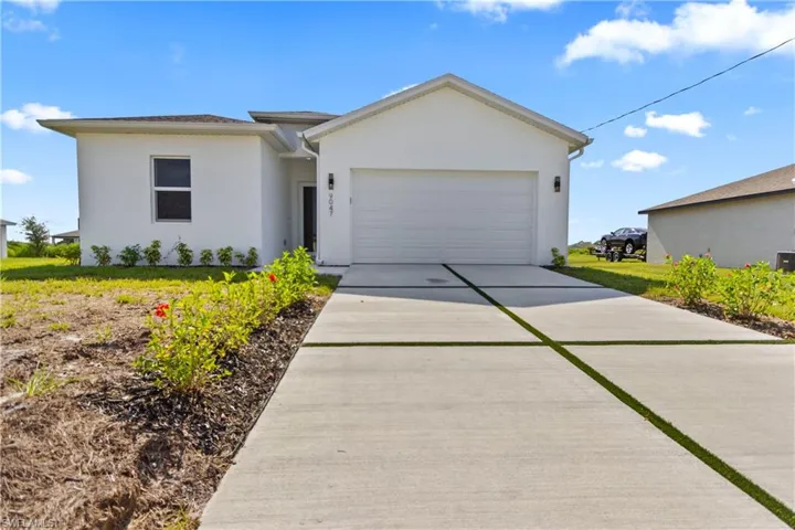 Single story home with an attached garage, concrete driveway, and stucco siding